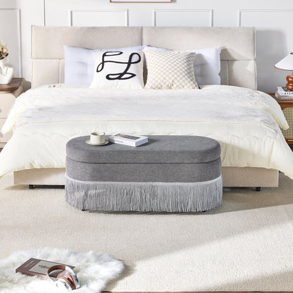 Oval Upholstered Storage Ottoman With Fringe Trim & Lift Top Lid